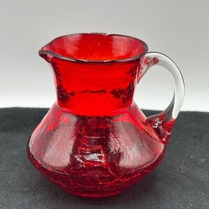 Vintage Mid Century red crackle pitcher with applied glass handle. 31/2"x 31/2"